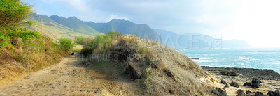 Buy stock photo Trail, landscape and sky with ocean in nature for travel, adventure or hiking with mountain view in Hawaii. Pathway, gravel road or location with rocks, roadway or environment for holiday or vacation
