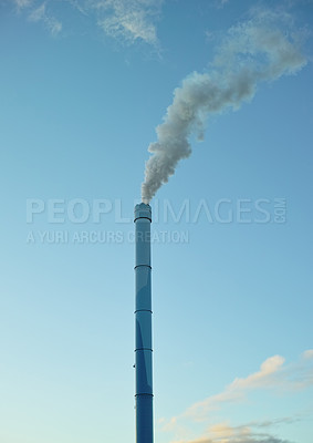 Buy stock photo A factory chimney with smoke billowing into the air. Large amounts of steam or smoke billowing from an industrial smoke stack, adding to pollution and air contamination from big industrial industries