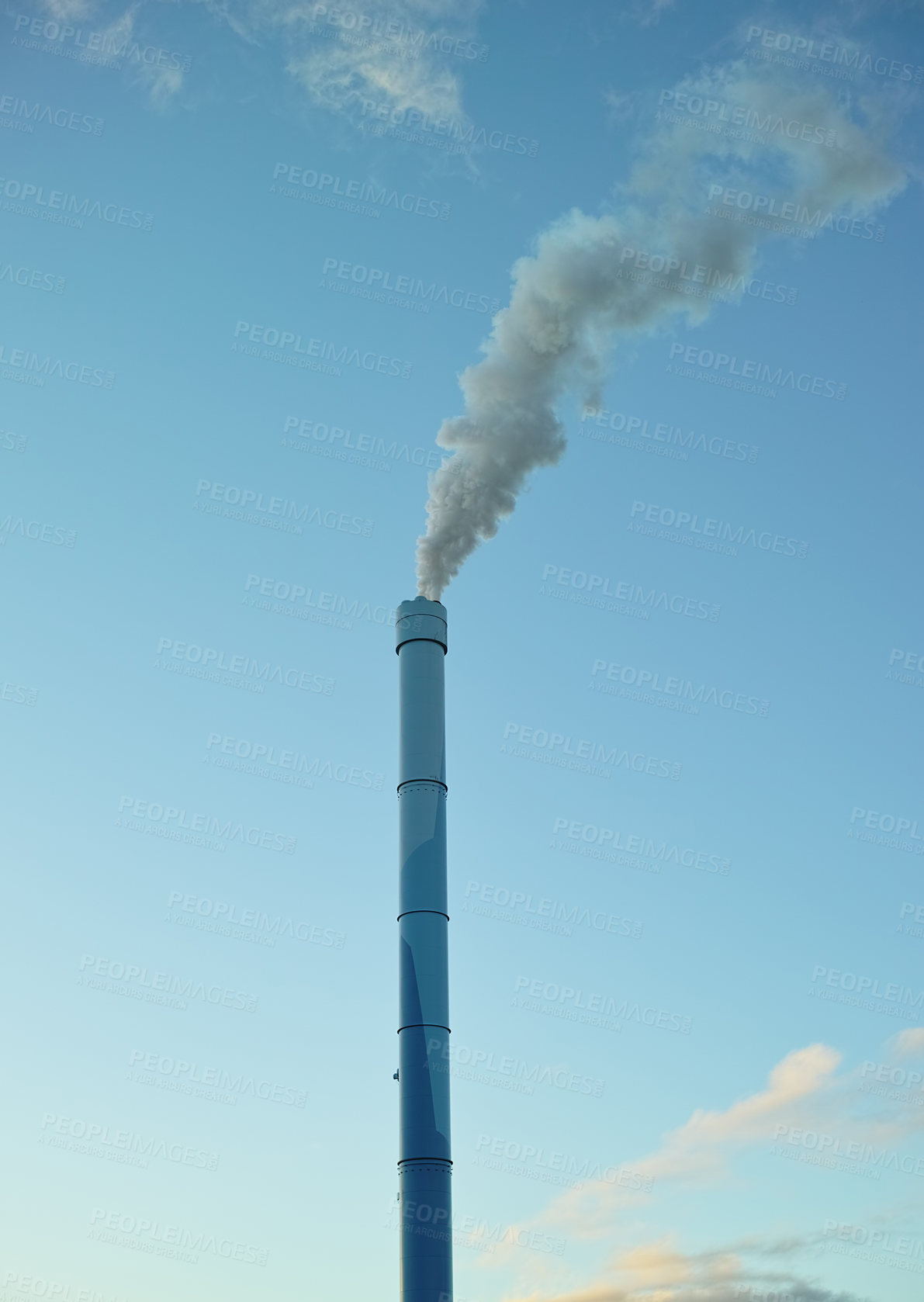 Buy stock photo A factory chimney with smoke billowing into the air. Large amounts of steam or smoke billowing from an industrial smoke stack, adding to pollution and air contamination from big industrial industries