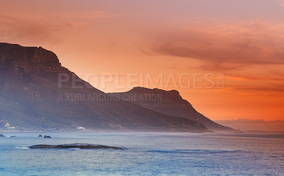 Buy stock photo Ocean, sunset and mountains in nature or sustainable environment and travel destination for vacation. Landscape, sea or sunlight on water on beach, calm or seascape of camps bay for tourist adventure