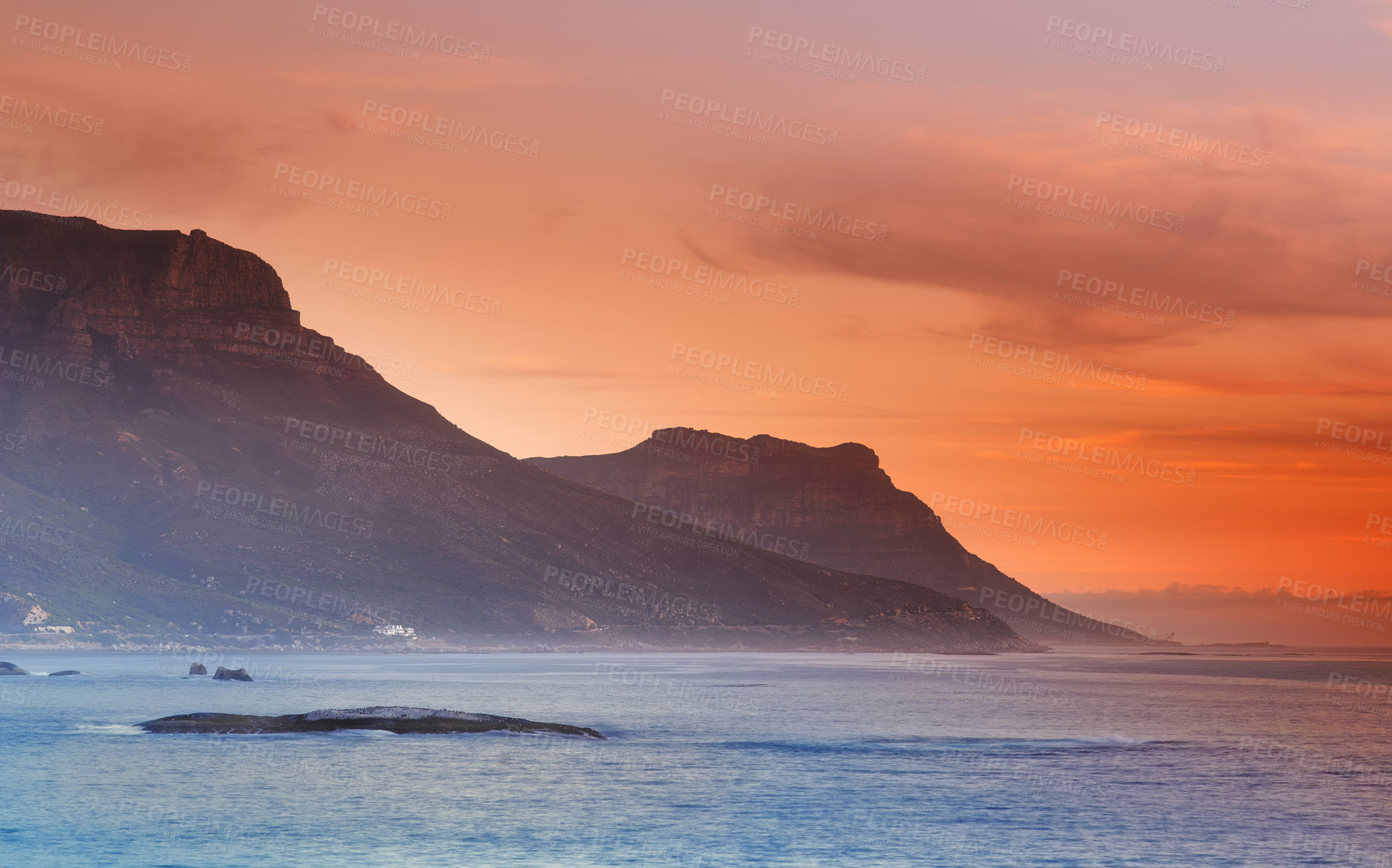 Buy stock photo Ocean, sunset and mountains in nature or sustainable environment and travel destination for vacation. Landscape, sea or sunlight on water on beach, calm or seascape of camps bay for tourist adventure