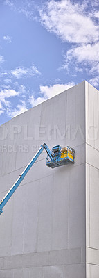 Buy stock photo A hydraulic lift platform carrying boxes against grey wall building. Forklift or transport machinery used in construction and logistics industry for raising workers or as heavy duty freight elevators