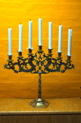Buy stock photo Candle, vintage and holder in church on table at interior of room or cathedral. Wax, brass and retro candlestick for decoration at temple, wood and copper metal with antique candelabra for lighting