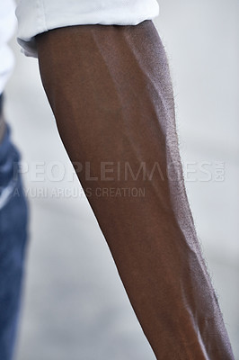 Buy stock photo Strong, arm and person with vein from muscle and shirt, fashion or closeup in white background. African, skincare and forearm of model with healthy fitness, wellness or muscular bodybuilder in office