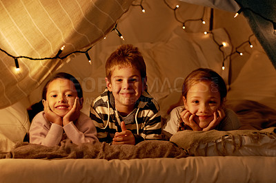 Buy stock photo Shot of three young children in a tent together