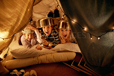 Buy stock photo Shot of cute little children with pot helmets in a blanket fort