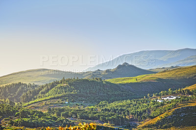 Buy stock photo Mountains, environment and blue sky with nature, countryside and sunshine with landscape or weekend break. Empty, valley or grass with flowers or vacation with summer or travel with holiday or spring