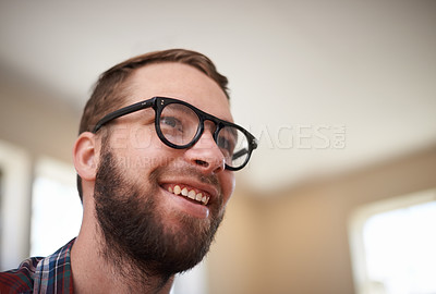 Buy stock photo Man, laughing and happy with humor in home, satisfaction and cheerful in living room. Male person, comic and relax in apartment or confident with funny joke, smile and pride for silly or goofy comedy