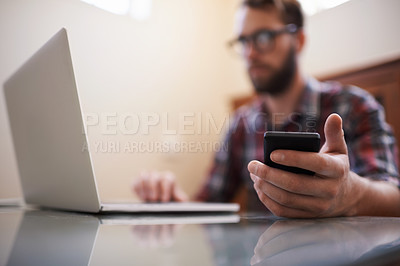 Buy stock photo Shot of a handsome young hipster working on a laptop