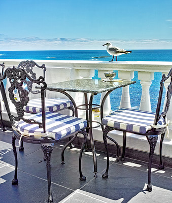 Buy stock photo Tables and chairs on the balcony of a seaside restaurant