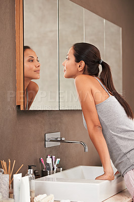 Buy stock photo Bathroom, mirror and woman check face for skincare, beauty and wellness in morning routine. Health, dermatology and person in reflection for pimple, acne or cleaning, hygiene and grooming at home