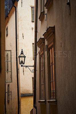 Buy stock photo Travel, alley and lantern on vintage building in old town with history, culture or holiday destination in Sweden. Vacation, architecture and antique lamp in Stockholm with retro light in ancient city