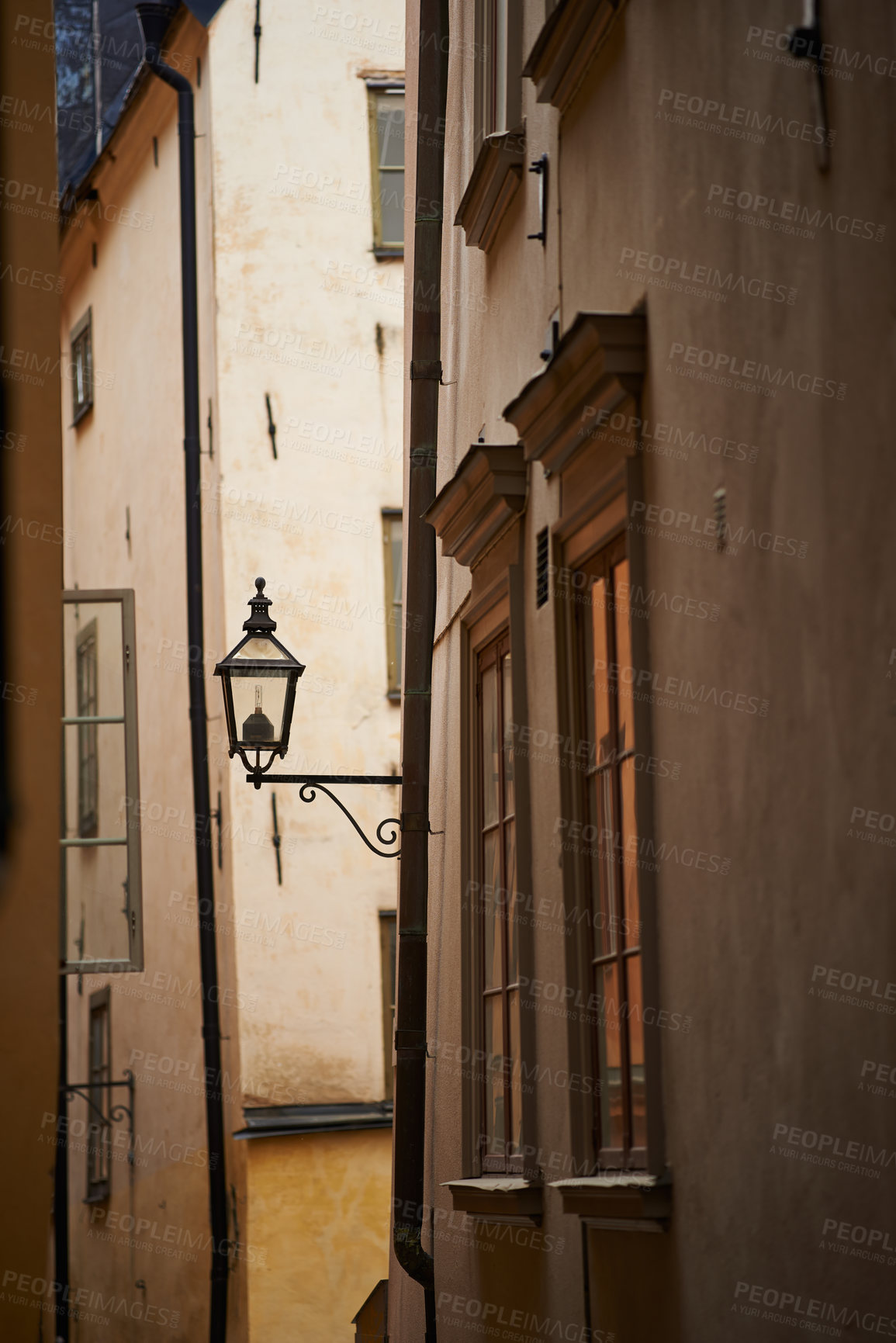 Buy stock photo Travel, alley and lantern on vintage building in old town with history, culture or holiday destination in Sweden. Vacation, architecture and antique lamp in Stockholm with retro light in ancient city