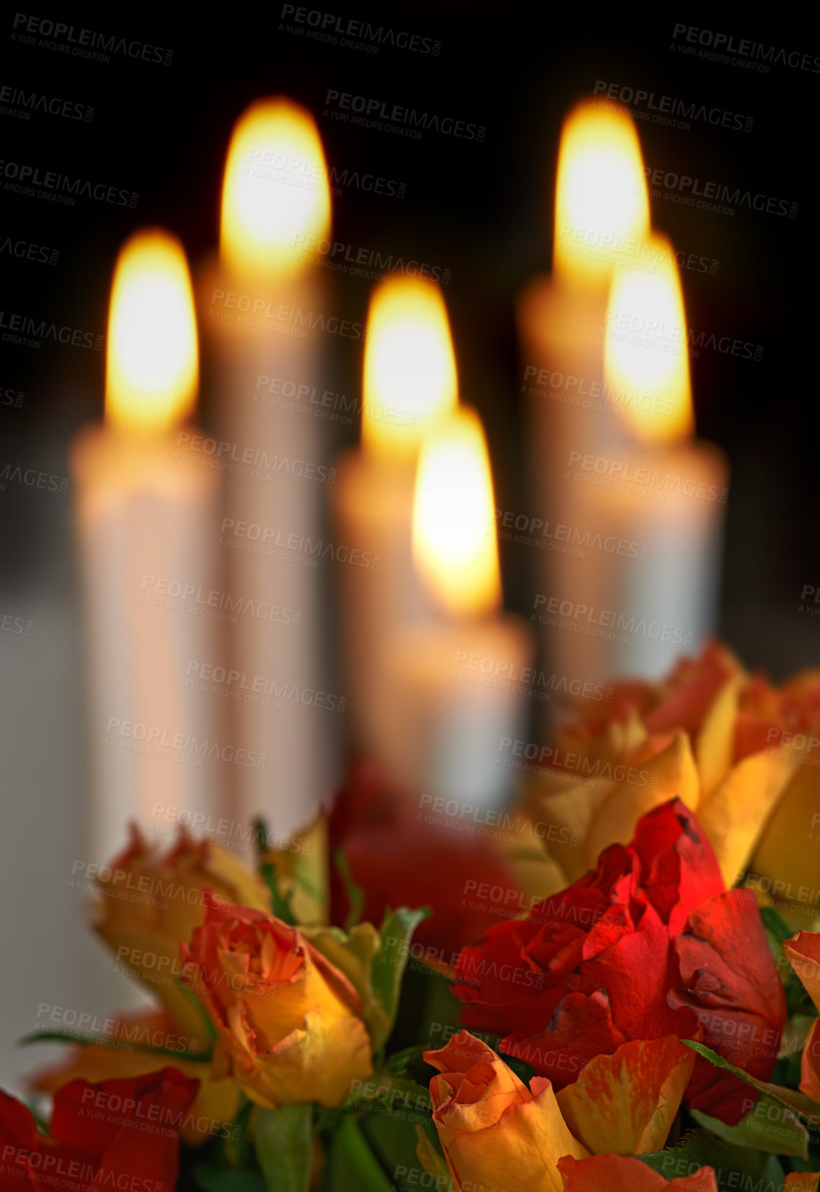 Buy stock photo Fresh colourful roses with lit candles in the background against dark copyspace. A romantic gesture, proposal, valentines day, birthday celebration or an apology, perfect setting for a date night
