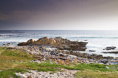 Buy stock photo A rocky coastline in the Western Cape, South Africa on a hot summer day. Clear skies and beaches, a perfect getaway filled with self care resorts and wellness outdoor activities with tropical weather