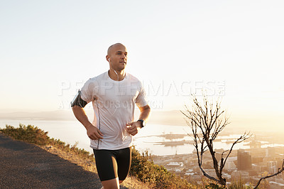Buy stock photo Athlete, man and running in road with music for sport, exercise and fitness for competition or marathon in nature. Runner, person and workout with wellness, seaside and earphones for cardio in Mexico