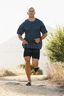 Buy stock photo Fitness, running and man on path in mountain for health, wellness and strong body development. Workout, exercise and runner on road in nature for marathon training, performance and morning challenge.