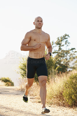 Buy stock photo Man, shirtless and running outdoor for fitness, cardio and health in park with fresh air and training for marathon. Sports, exercise and athlete in nature for workout, wellness and endurance for body