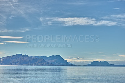 Buy stock photo Ocean, blue sky and mountains in nature for travel, tourism destination or vacation with landscape background. Sea, surface and water reflection by island for eco friendly adventure and Norway mockup