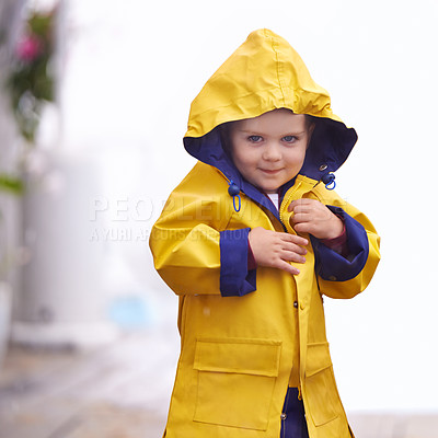 Buy stock photo Shot of a young boy playing outside in the rain