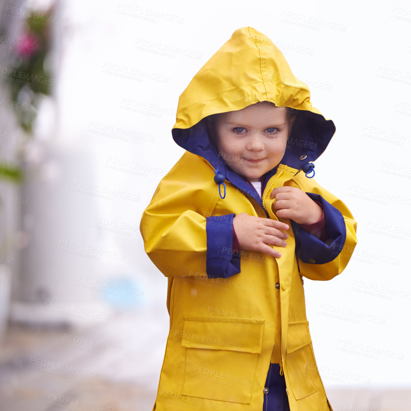 Buy stock photo Shot of a young boy playing outside in the rain