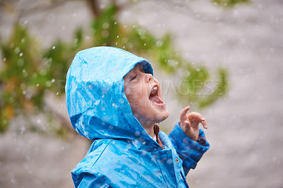 Buy stock photo Boy, jacket and rain in winter with playing for fun, carefree childhood and happiness with freedom. Child, excited and smile with mouth open in nature for vacation, weekend or holiday in cold weather