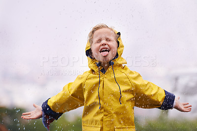 Buy stock photo Winter, raincoat and a girl tasting the rain outdoor alone, having fun during the cold season. Kids, water or wet with an adorable little female child playing arms outstretched outside in the day