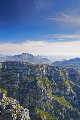 Buy stock photo Mountains, landscape and clouds in sky for travel, hiking or eco friendly tourism by ocean or sea on horizon. Aerial view of environment, nature and rock texture or mockup in Cape Town, South Africa