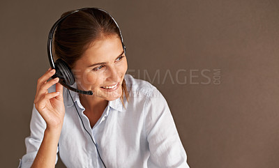 Buy stock photo An attractive young call center representative busy with a client