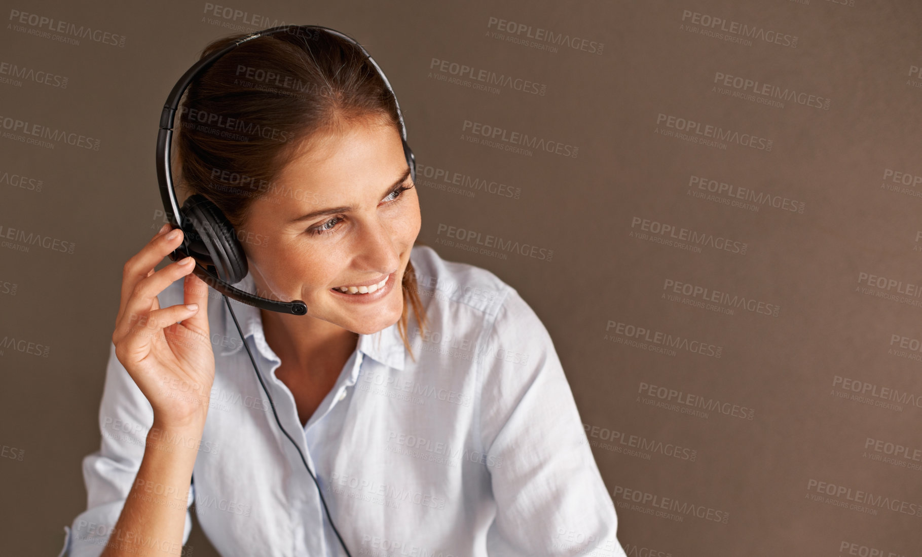 Buy stock photo An attractive young call center representative busy with a client