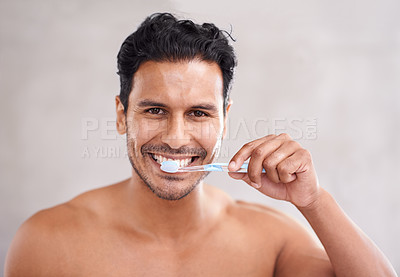 Buy stock photo Oral hygiene, portrait and man in bathroom for brushing teeth, self care and morning routine. Dental, smile and face of Mexican male person at home for wellness, toothbrush and healthy mouth.