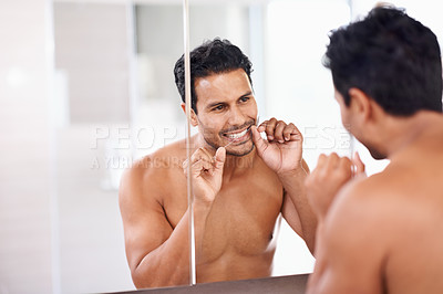 Buy stock photo Dental, flossing teeth and man in bathroom mirror for self care, morning routine and fresh breath. Oral hygiene, tooth and face of male person for wellness, healthy gums and cleaning with reflection.