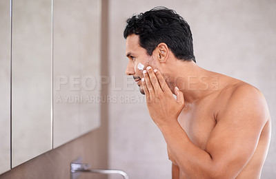 Buy stock photo skincare, face cream and man in a bathroom mirror with lotion, application or morning routine at home. Beauty, sunscreen and profile of male person in a house with skin, cosmetics or facial treatment