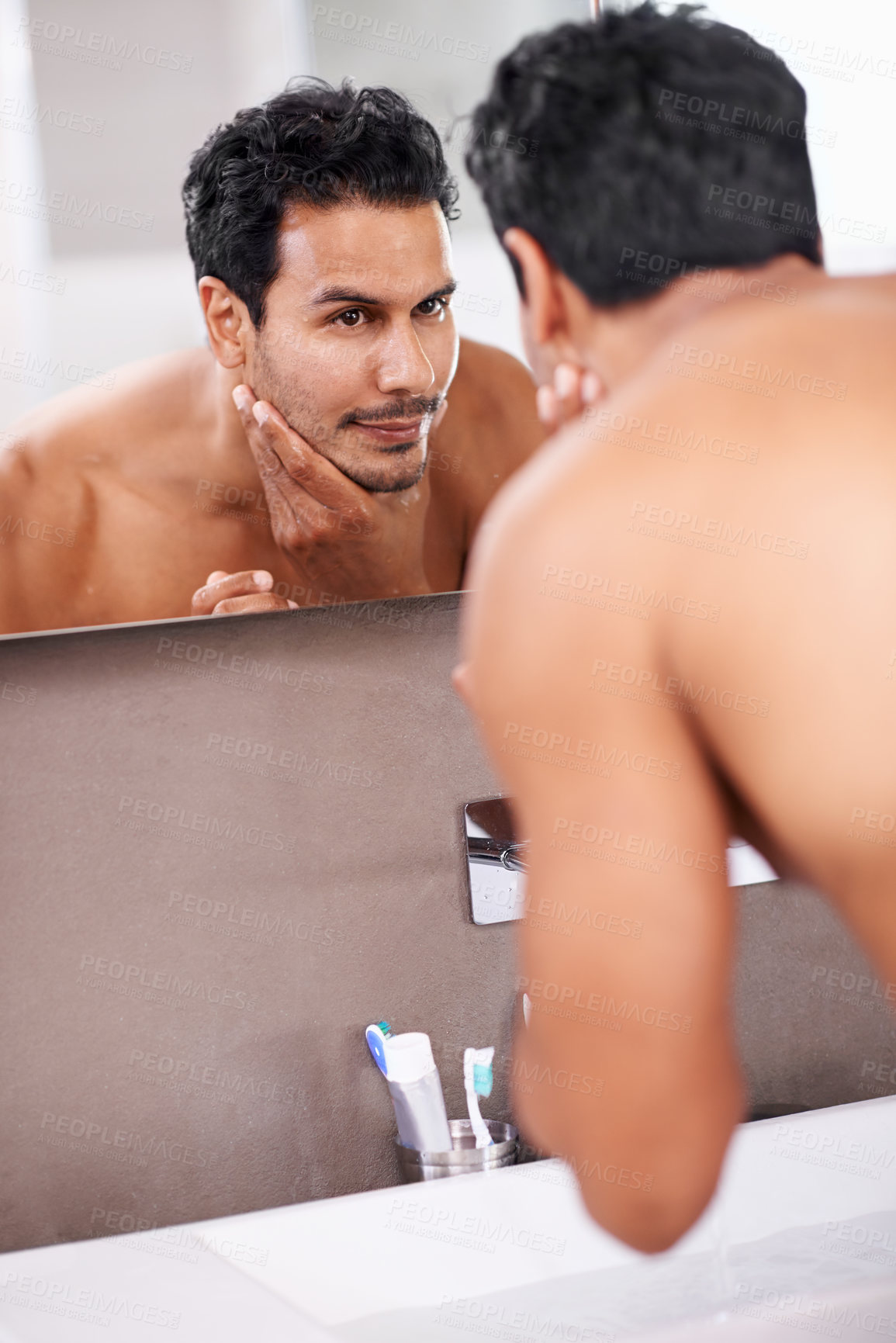 Buy stock photo Skincare, wellness and mirror with man in bathroom for grooming, cleaning and morning routine. Reflection, hygiene and face of male person for self care, dermatology and facial treatment in washroom.