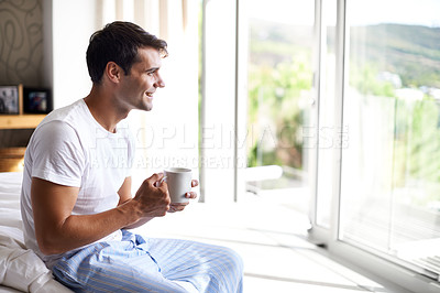 Buy stock photo Man, coffee and bedroom for happiness, smile and cup by window in house at holiday resort. Male person, happy and bed in pajamas or sleepwear for relaxation with tea or latte with drink at home.
