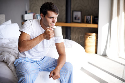Buy stock photo Man, home and morning coffee wake up and thinking on bed, weekend off in apartment to relax with attractive male person. Casual and holiday idea, Saturday off day and comfortable guy with cup