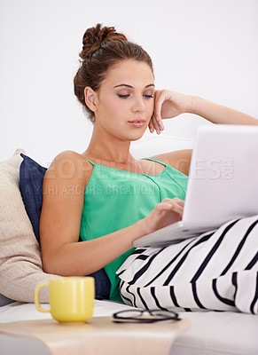 Buy stock photo Student woman, laptop and working on couch busy, searching and concentration with computer in living room. Female person, casual outfit and coffee on sofa or lounge, online and connectivity in house