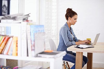 Buy stock photo Shot of an attractive woman using her laptop at home