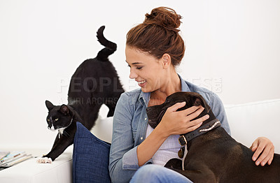 Buy stock photo Shot of a beautiful young woman relaxing on the couch with her dog and cat
