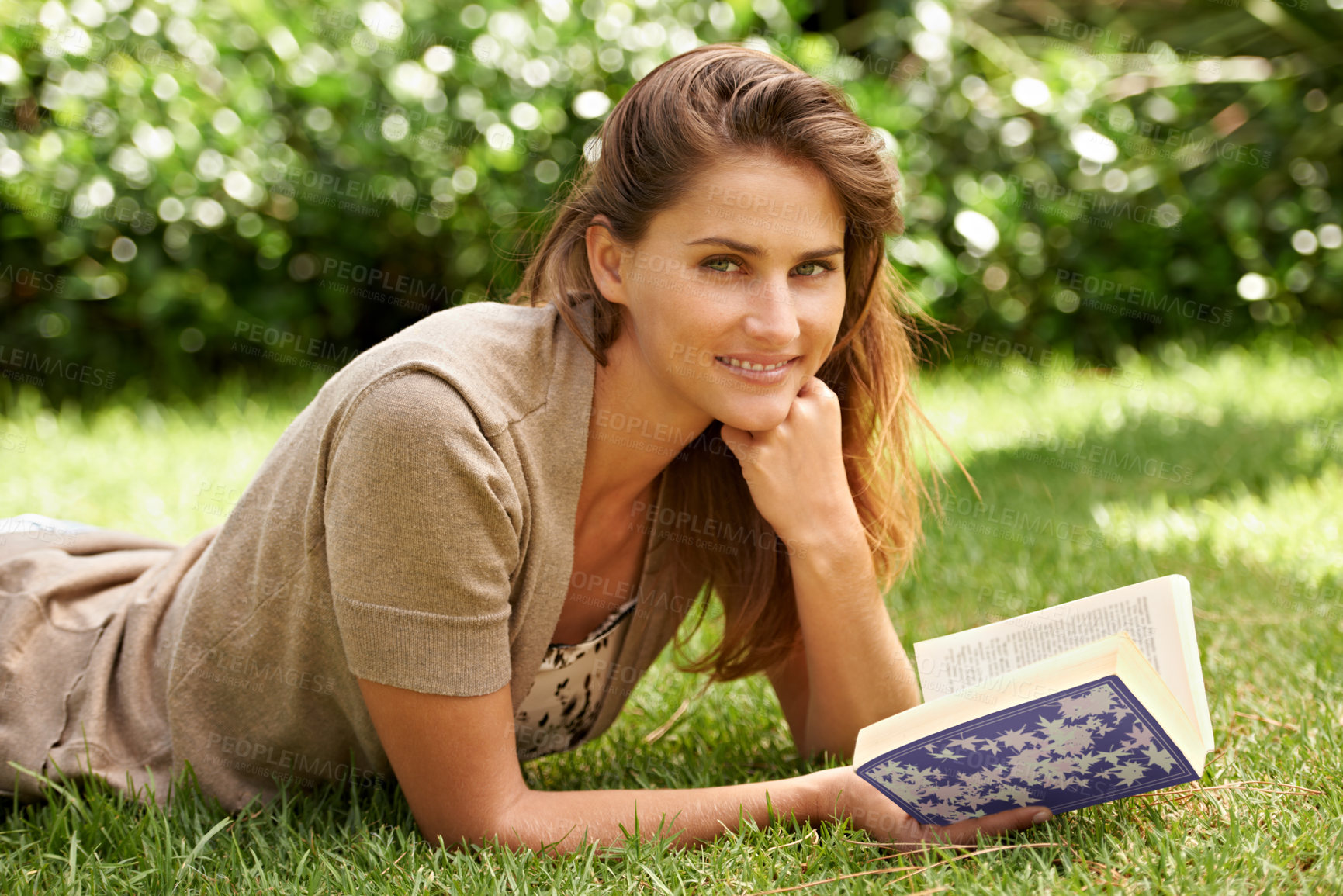 Buy stock photo Portrait, book and woman reading on grass, field and nature in garden, backyard and sunshine relax in summer. Female person, gen z girl and novel studying for learning, education and knowledge