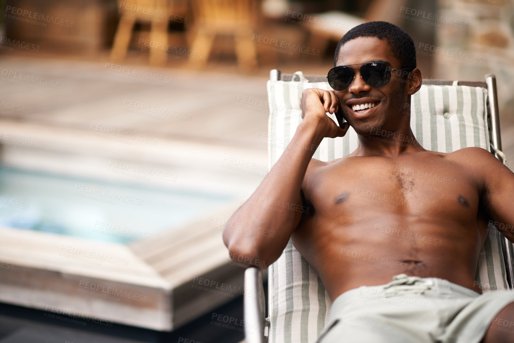 Buy stock photo A young man reclining in the summer sun