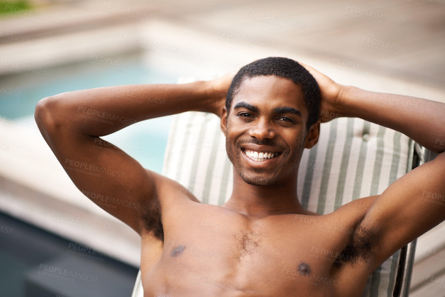 Buy stock photo Man, portrait and relax by pool on chair, happy and swimming on weekend for fun on summer holiday. Black male person, smile and calm or peace on travel to Nigeria, vacation and outdoors for leisure