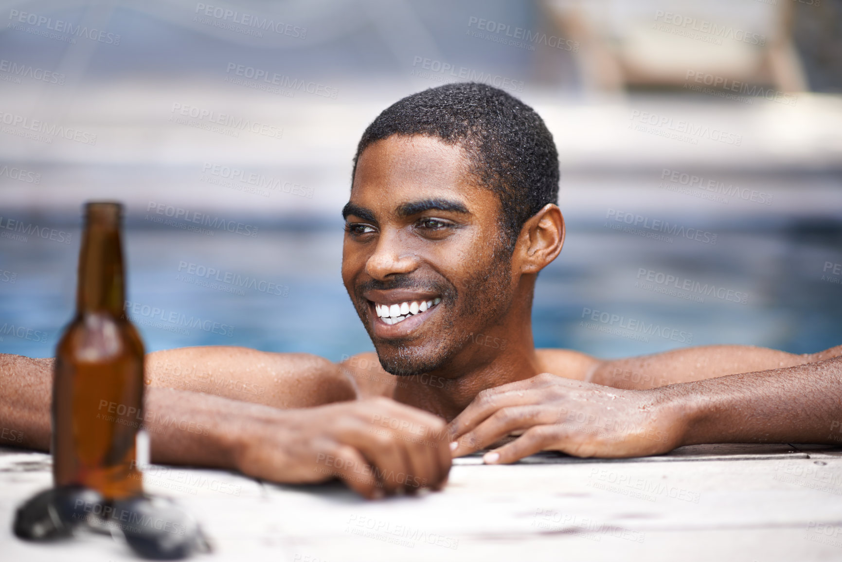 Buy stock photo Man, beer and relax poolside, happy and swimming on weekend for wellness on summer holiday. Black male person, luxury hotel and calm or peace on travel to Nigeria, vacation and alcohol outdoors