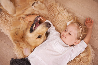 Buy stock photo Girl, dog and hug together on floor in living room and golden retriever, kid and relaxing with pet on lounge carpet. Young child, Labrador and bonding in family home, pets and dogs with children