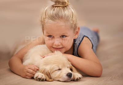 Buy stock photo Girl kid hug her puppy, relax at home and happy with sleeping golden retriever dog and child with smile. Happiness, pet care and love with young female and her domestic animal lying on wood floor