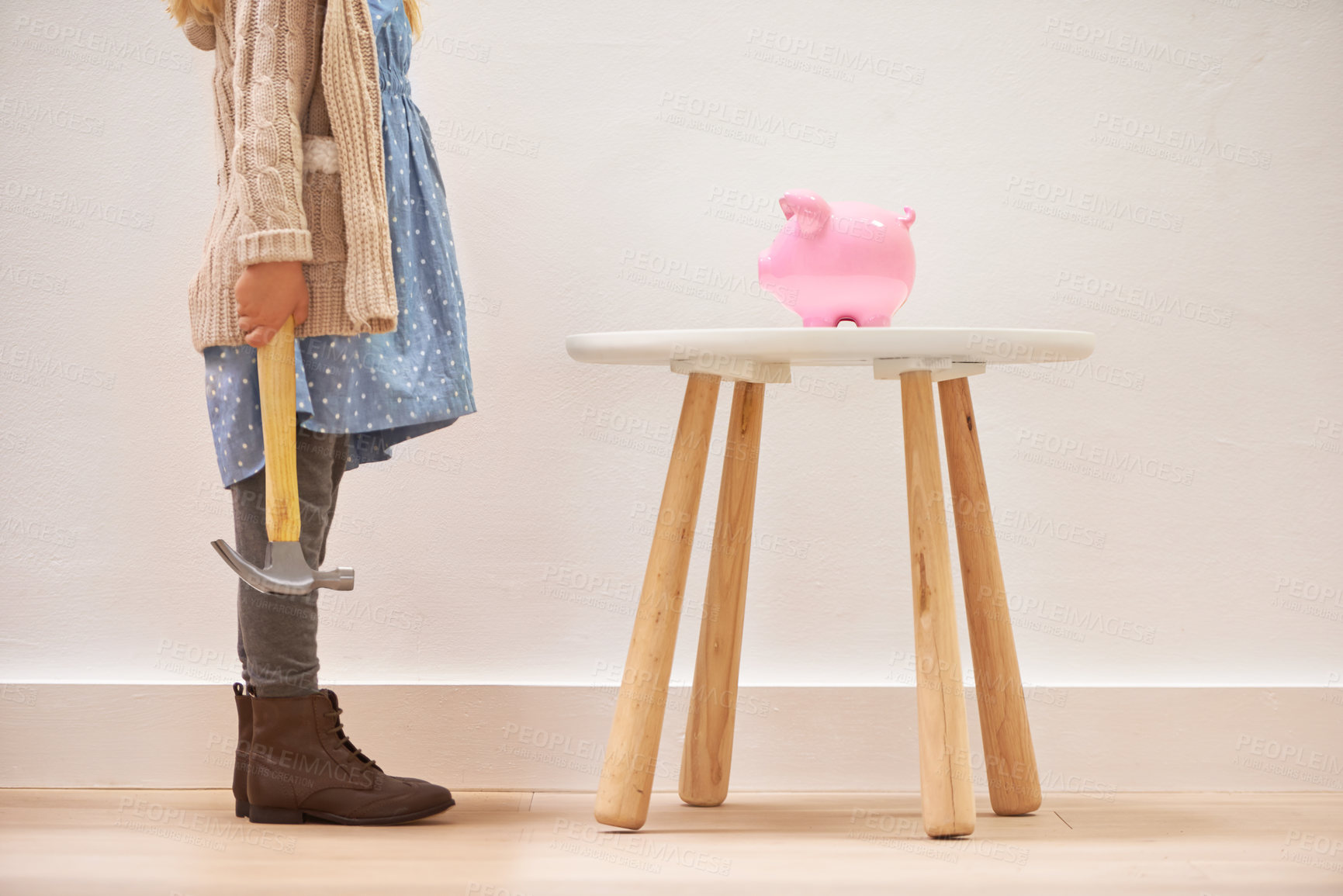 Buy stock photo Girl, hammer and piggy bank for savings or money, finance and investment for future in home. Female person, child and waiting for profit or wealth, cash growth and tool to break a money box to spend