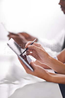 Buy stock photo Cropped shot of two businesspeople using their touchpads