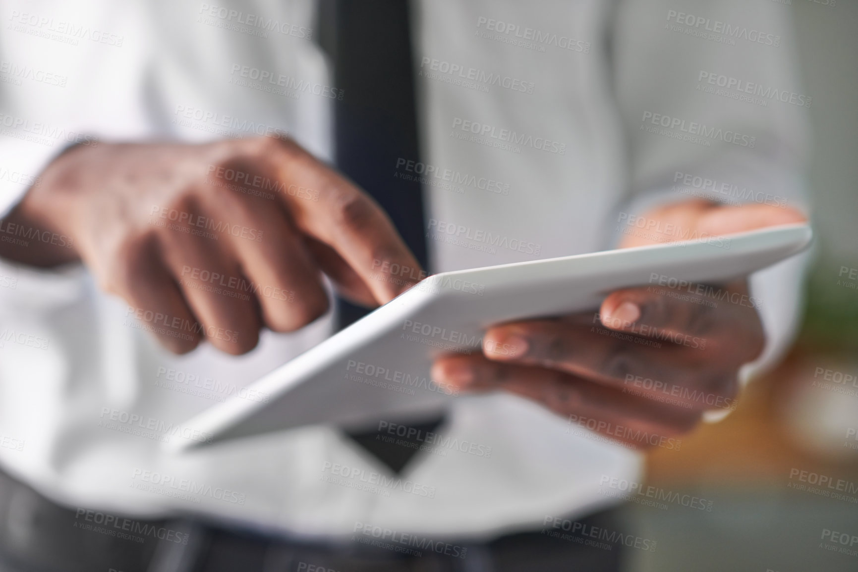Buy stock photo Shot of a man touching his digital tablet