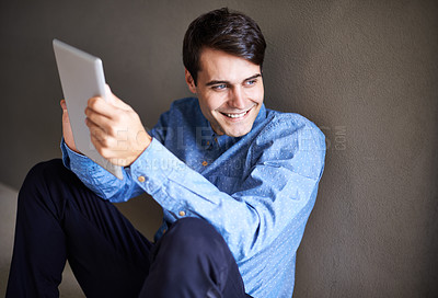 Buy stock photo Man, tablet and online for planning on floor, professional and research for startup company. Happy businessperson, ground and app for information in office, networking and internet for communication