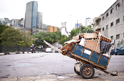 Buy stock photo Shot of a cart full of garbage in the street of a poverty-stricken city